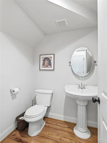 A powder room is conveniently located near the common areas.