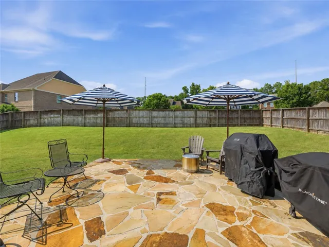 Beyond the covered porch is a fabulous flagstone patio—an ideal spot for grilling or simply enjoying the spacious, private yard.