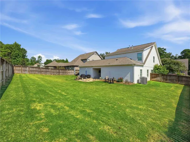 With full fencing and a wide, usable footprint, the yard delivers both privacy and space--one of many highlights of the property.