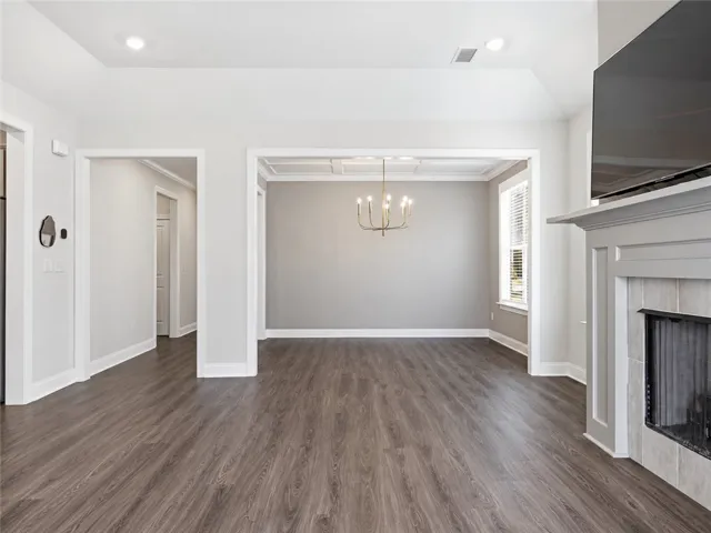 An open floor plan connects the living room fireplace to a formal dining space.
