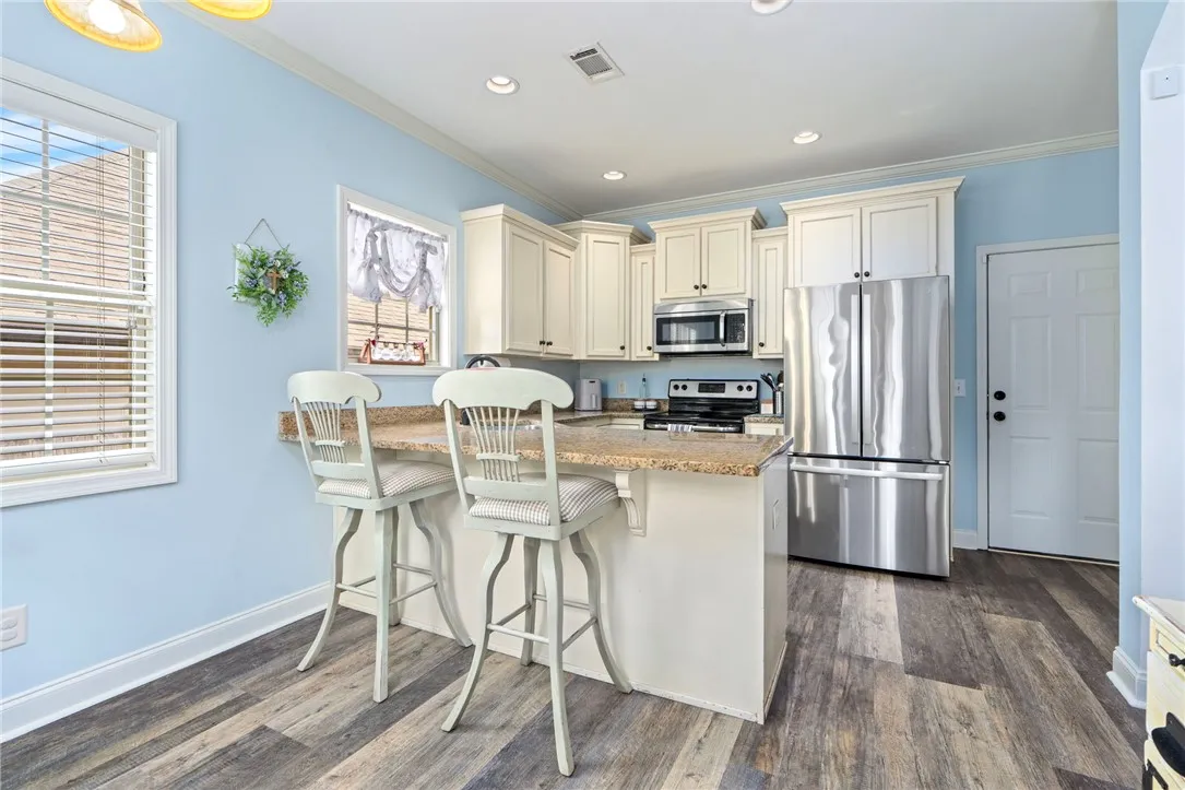 Kitchen provides ample cabinet space and additional bar seating.