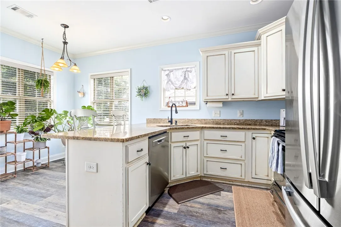 Kitchen provides ample cabinet space and additional bar seating.