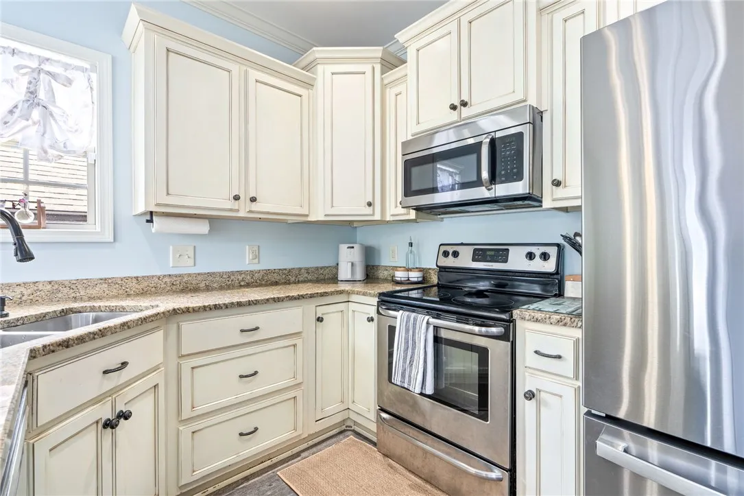 Kitchen provides ample cabinet space and additional bar seating.