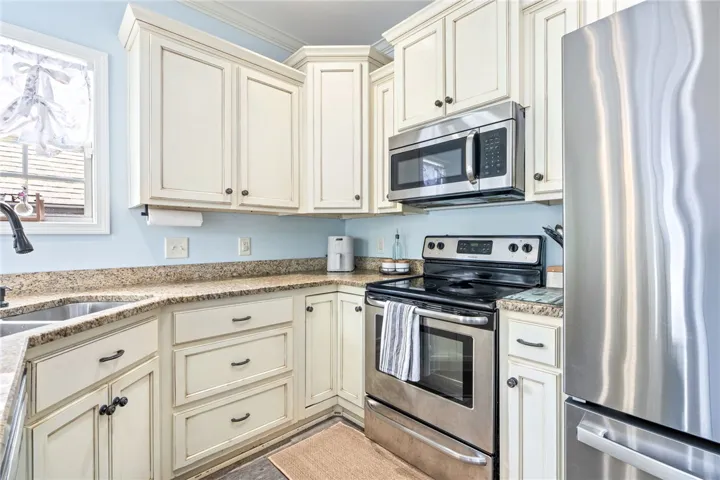 Kitchen provides ample cabinet space and additional bar seating.