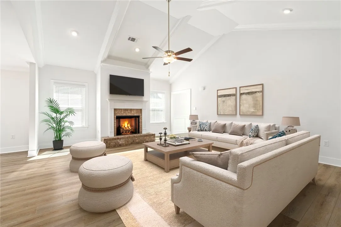 Virtually staged -An inviting fireplace anchor this airy living room with impressive vaulted ceiling.