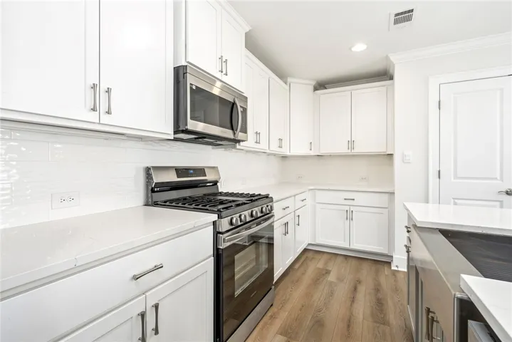 All appliances remain including gas stove and upscale refrigerator.