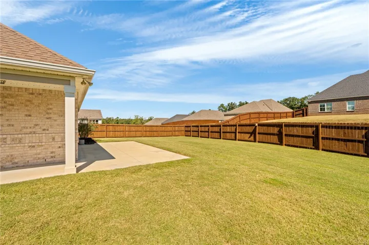 Fully fenced back yard with extra large patio
