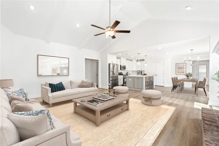 Virtually stage-Vaulted ceilings and beautiful flooring enhance the inviting, open layout of this main living area.