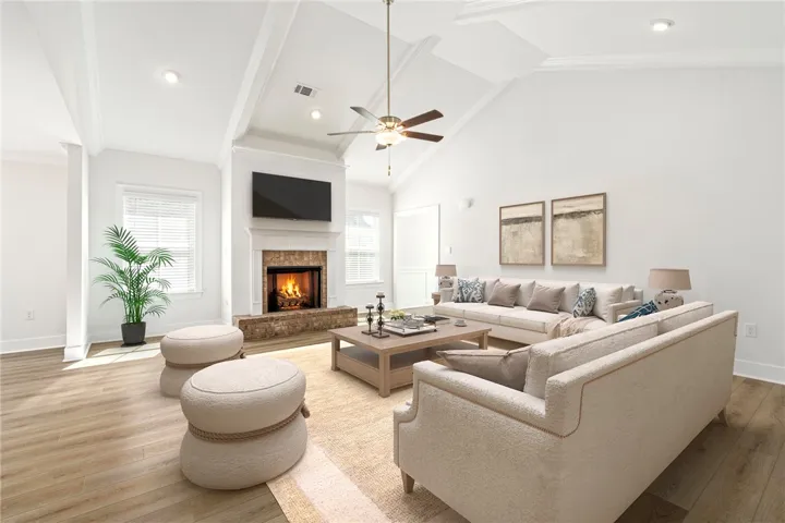 Virtually staged -An inviting fireplace anchor this airy living room with impressive vaulted ceiling.