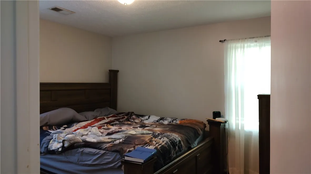 This is the second bedroom, no ceiling fan and  has wood floor