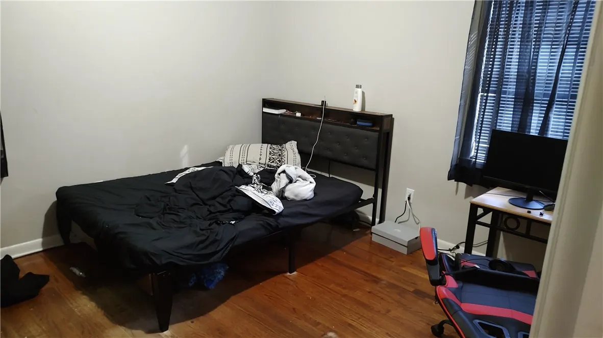 Bedroom with wood floor, no ceiling fan