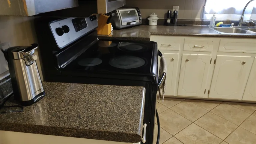 The kitchen counter tops and tile flooring.