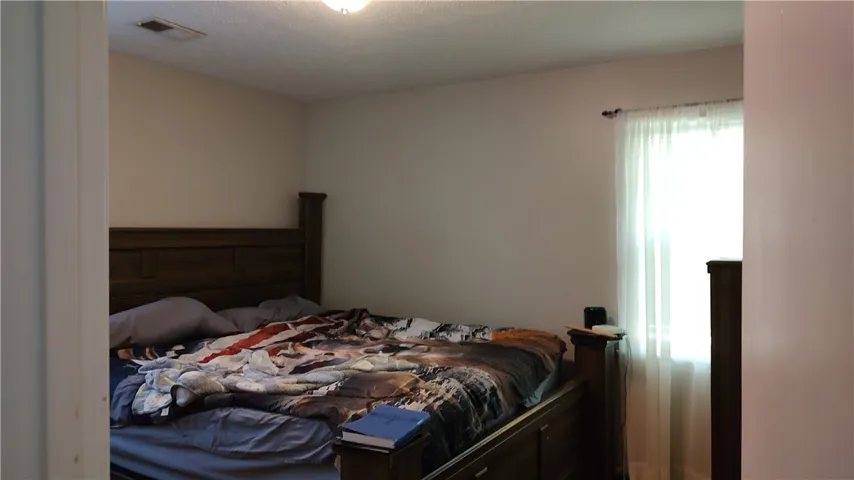 This is the second bedroom, no ceiling fan and  has wood floor