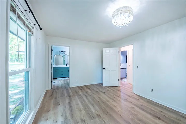 Rich wood-textured flooring complements the clean design of this inviting space with en suite access.