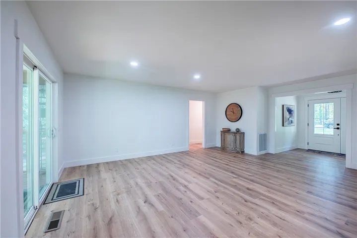 Gleaming LVP floors span this open interior connecting the entry and main living area.