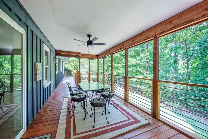 Natural wood decking and exposed timber posts frame views of the surrounding forest and golf course