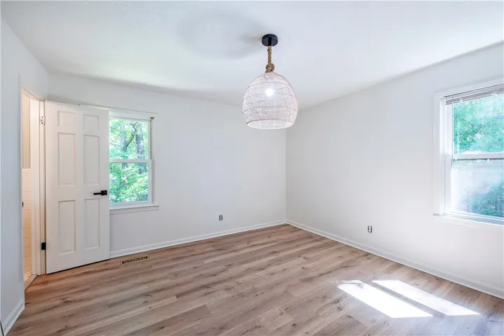 Natural light pours across the wood floors of this versatile space.