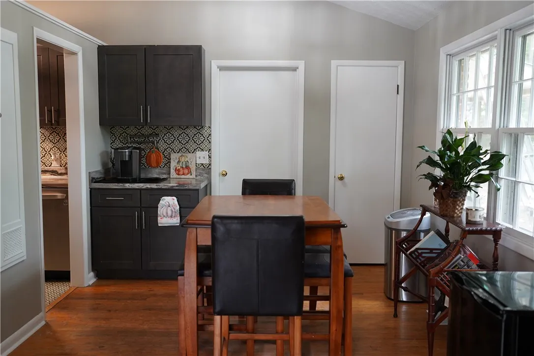 Rich wood floors lay a warm foundation for this cozy dining area and dry bar.