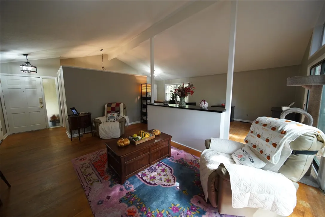 Gleaming hardwood floors and vaulted ceilings elevate this open living area.