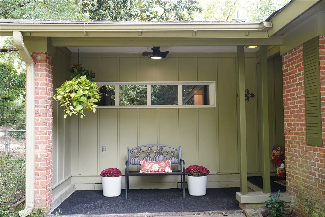 Warm brick details and vertical siding frame this inviting covered entry porch.