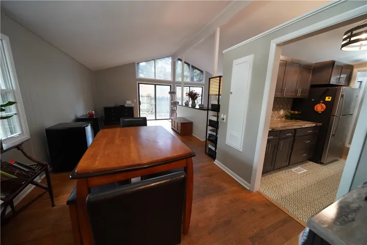 Angled high ceilings and warm wood flooring define this open-concept main-level living space.