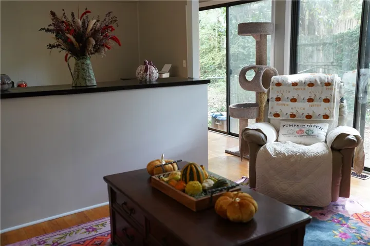Hardwood floors and massive sliding glass doors create a seamless connection to the outdoors.