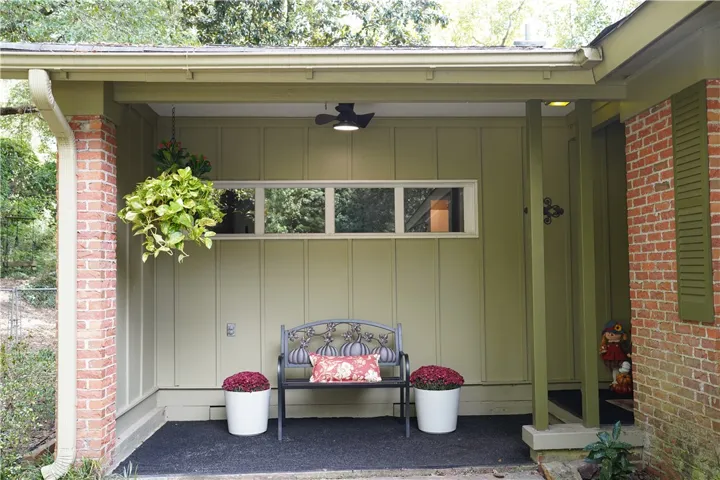 Warm brick details and vertical siding frame this inviting covered entry porch.