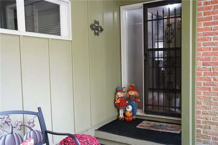 A welcoming front entry features vertical siding accented by classic brickwork.