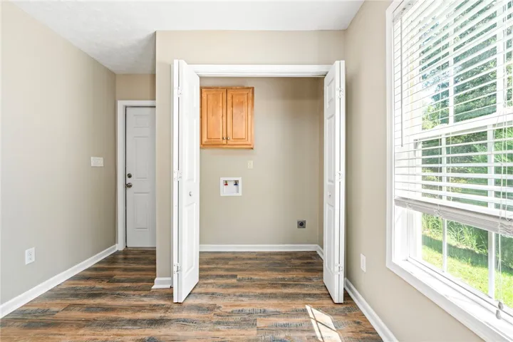 Laundry area with access door to the exterior driveway