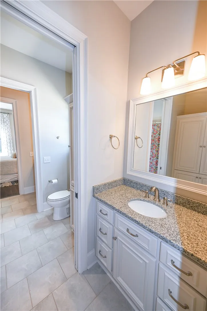 Jack and Jill bath connecting main level bedrooms 2 and 3.