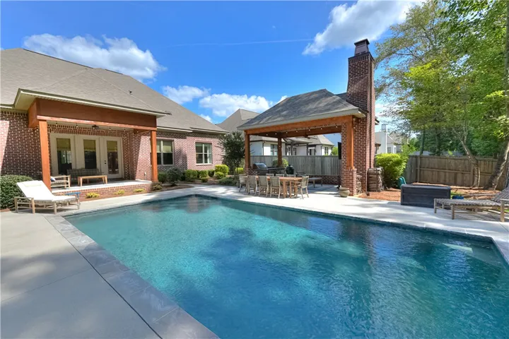 Amazing outdoor living spaces include both a covered back porch AND detached pool cabana!