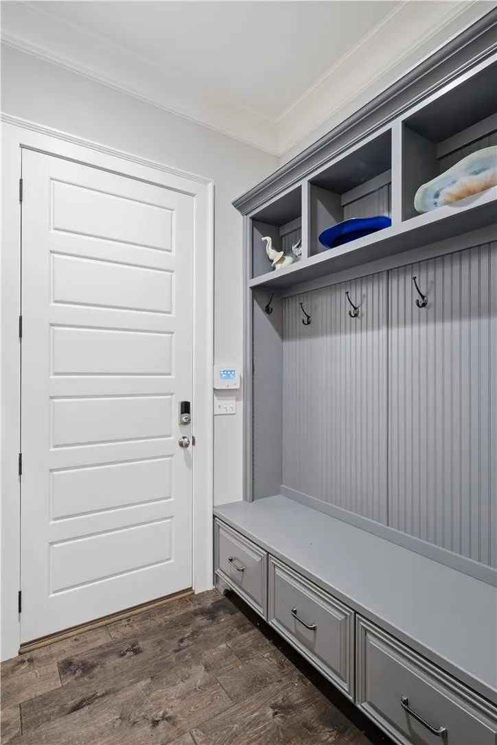 Located at the owner’s entry, a mud bench with drawers, hooks, and cubbies creates a convenient drop zone tucked out of guests’ view.
