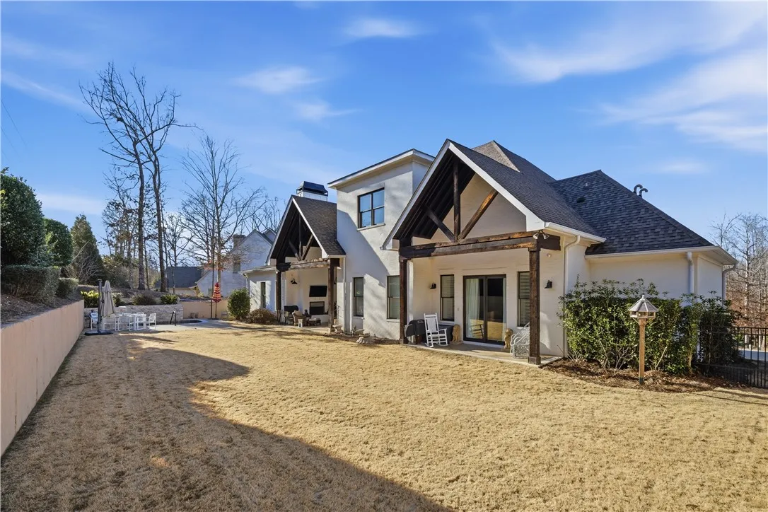 The tremendous backyard is perfectly flat and hemmed in by a wall, fence, and tiered landscaping.