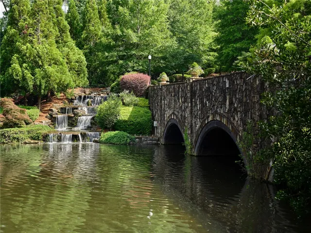 A gorgeous stone bridge and waterfall welcome residents and guests to the neighborhood.