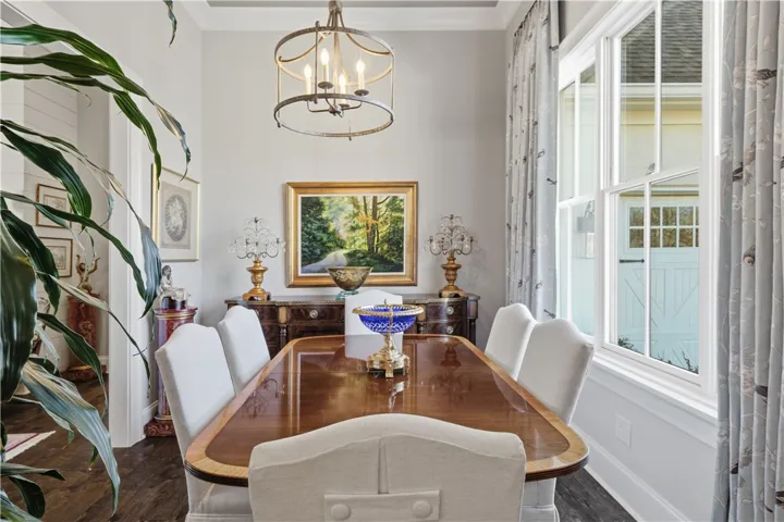 Large windows and high ceiling in the dining room lend to the elegant space.