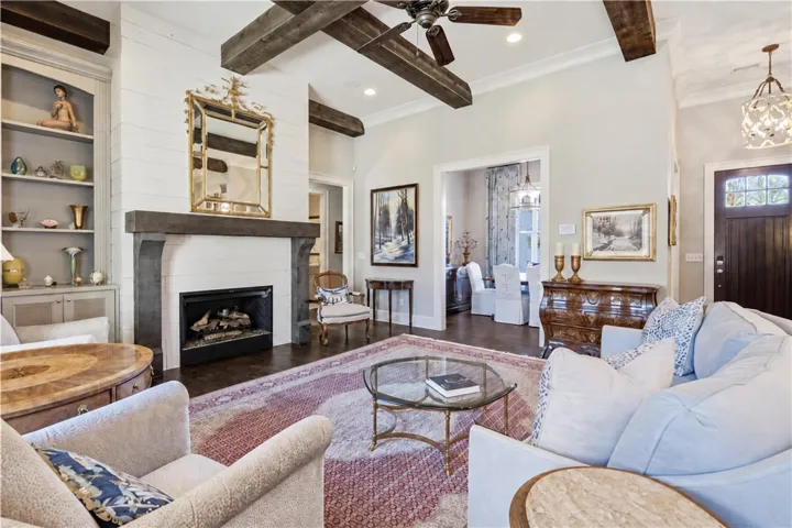 A substantial gas fireplace with a shiplap surround, paired with built-in cabinetry, anchors the great room.