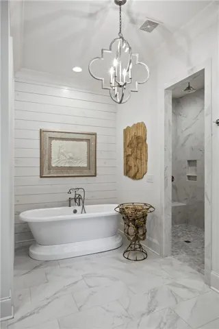 The primary bath is a show stopper. The soaking tub, set against a shiplap wall is the focal point of the gorgeous space.