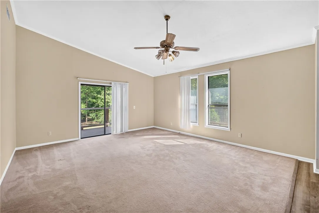 Large windows and a sliding door that leads to the new deck