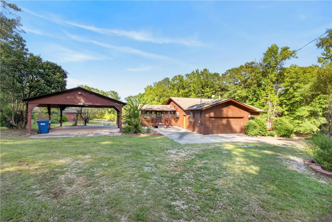 Front of home with double garage and a covered parking area
