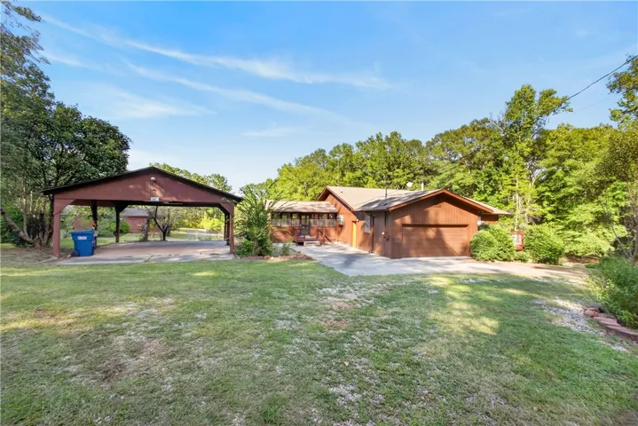 Front of home with double garage and a covered parking area