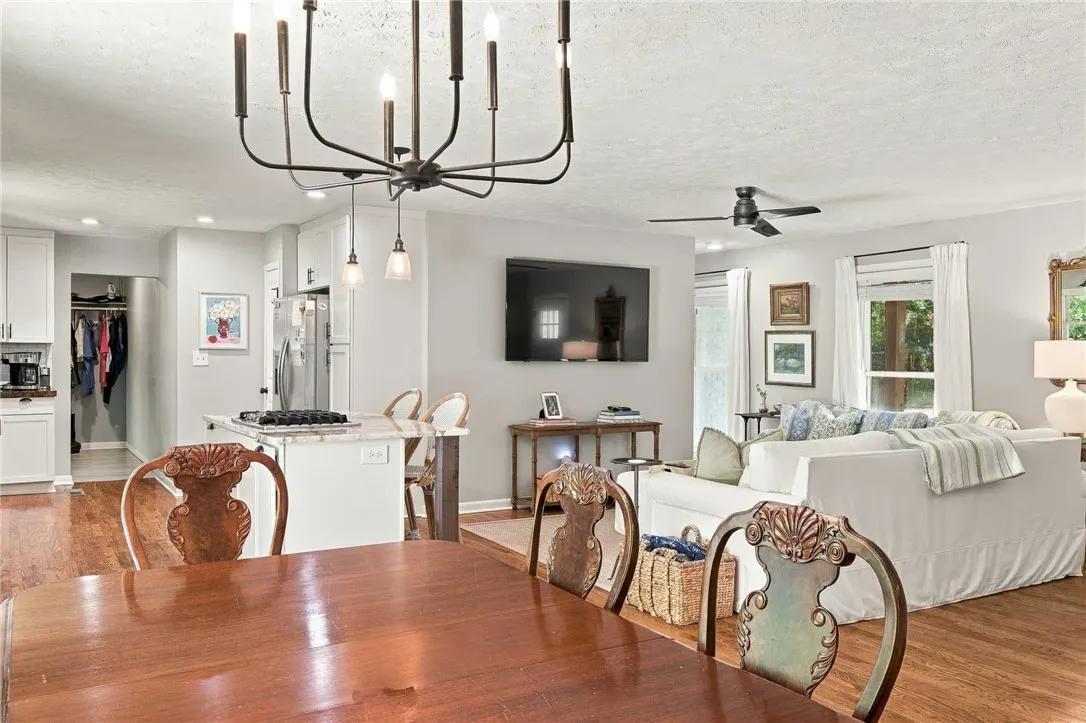 Rich hardwood flooring anchors this light-filled open concept living and dining space.