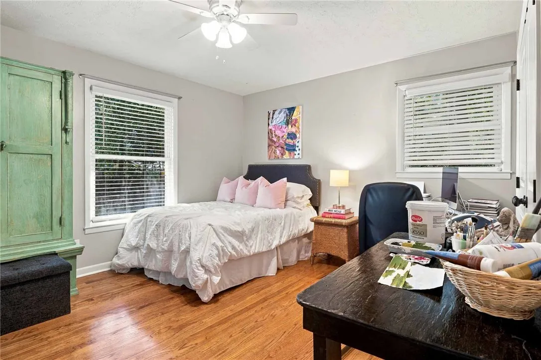 Gleaming hardwood floors and classic wood-framed windows anchor this serene space.