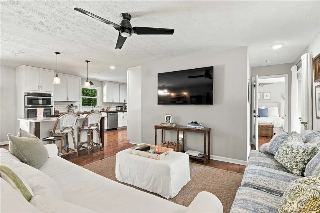 An open floorplan seamlessly connects the living space with a modern kitchen.