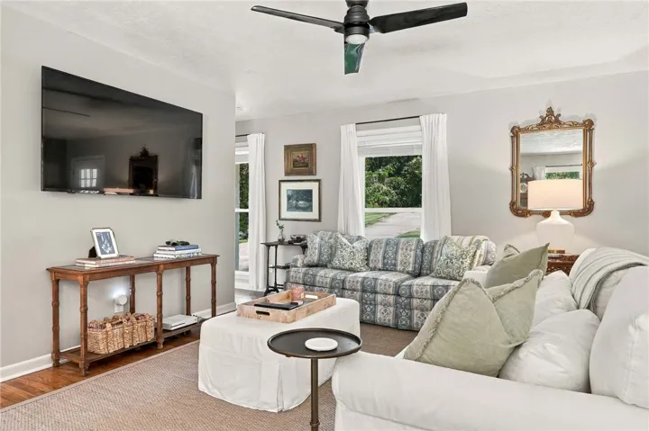 Gleaming hardwood floors and classic crown molding anchor this inviting living space.