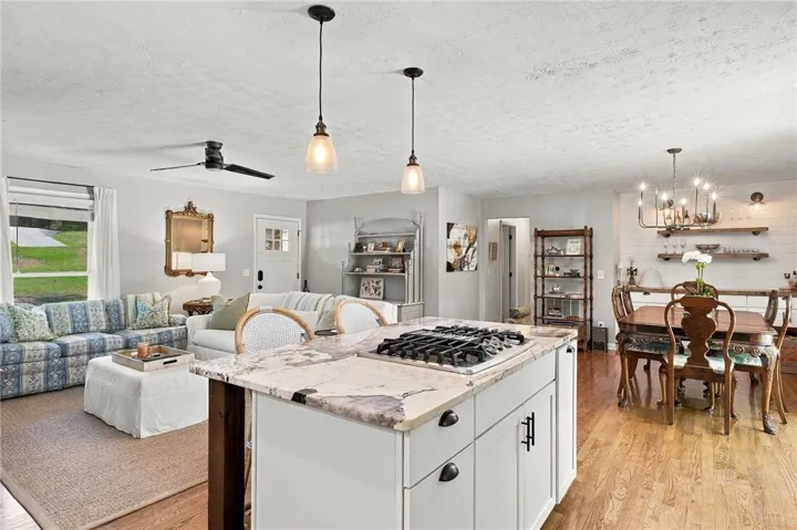 Granite counters highlight a spacious kitchen island in this open-concept main living area.
