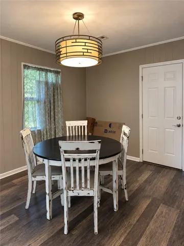 Rich wood plank flooring sets a warm foundation in this inviting dining space.