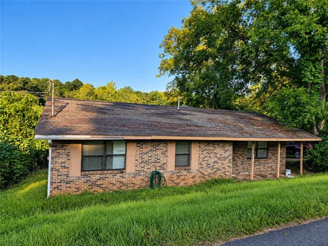 Classic brick siding and a covered front porch define this single-level home.