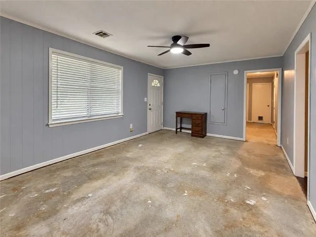 Concrete floors pair with vertical wall paneling to create a blank canvas for design.