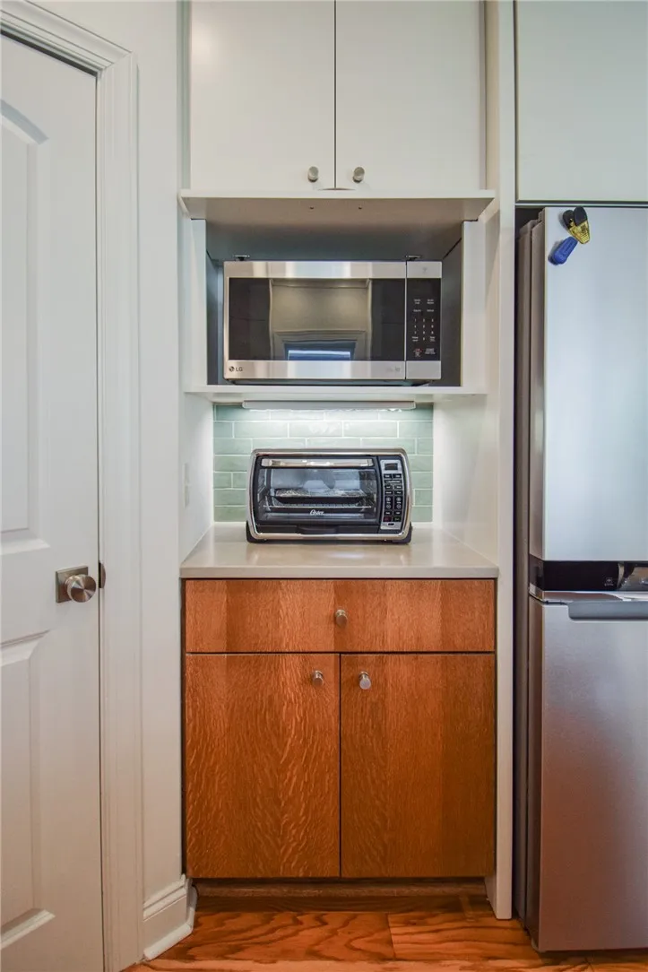 Rich wood cabinetry and clean stone countertops create an efficient kitchen workspace.