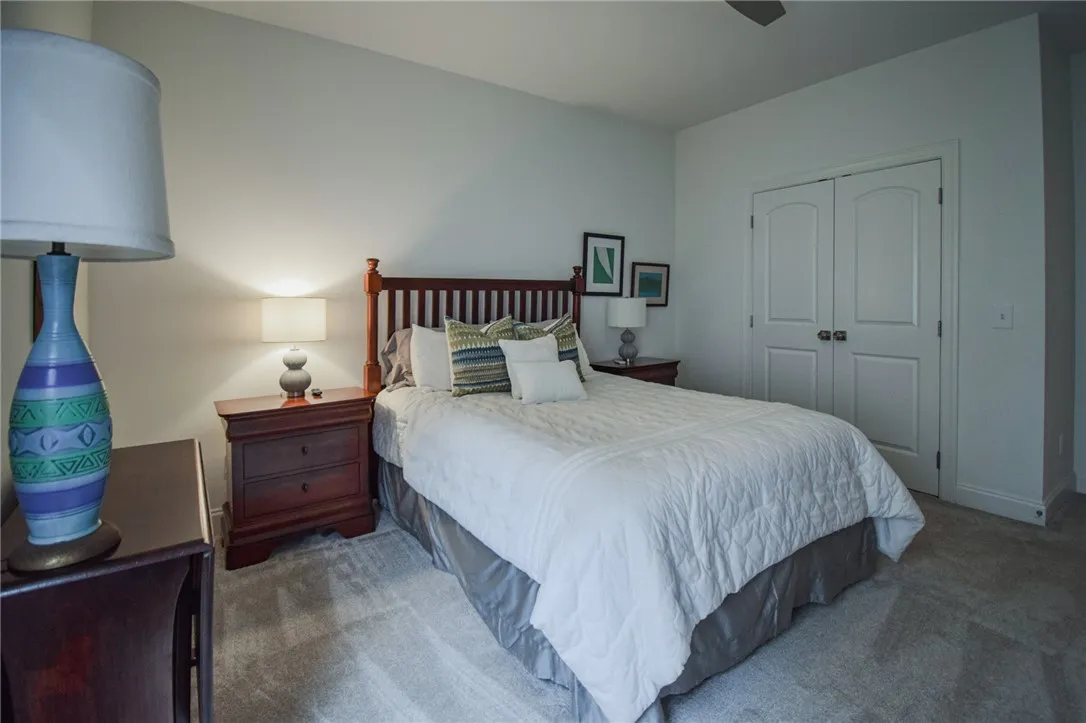 Plush carpeting anchors this inviting space featuring a large closet with double doors.